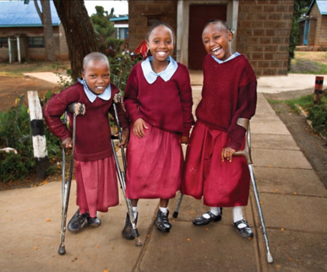 People interacting inclusively with a person in a wheelchair